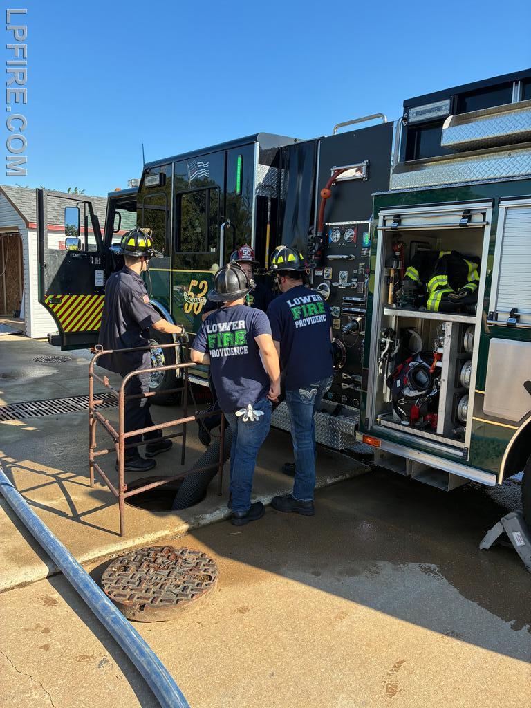 Firefighters Bogle and Harrison learning how to operate the pumps of the Engine